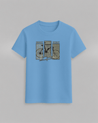 Bike T-Shirt in light blue cotton featuring a stylish graphic of a bicycle with text 'ENJOY EVERY moment' in multicolor blocks